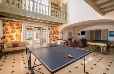 a large room with a ping pong table in it at Casa da Vigia - waking up in front of the sea in Albufeira