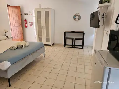 a bedroom with a bed and a tiled floor at Blife Benya private apartment in Faro