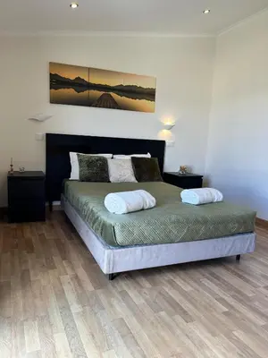 a bedroom with a bed with two pillows on it at Fernandes Holidays in Quarteira