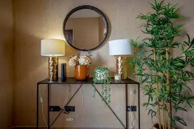 a table with two lamps and a mirror on a wall at Mary's Ocean in Albufeira