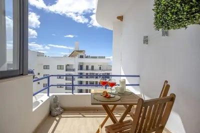 a table and chairs on a balcony with a view at Mary's Ocean in Albufeira