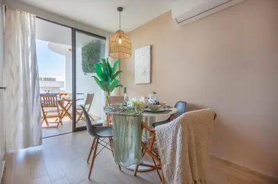 a dining room with a table and chairs in a room at Mary's Ocean in Albufeira
