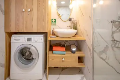 a bathroom with a washing machine and a sink at Mary's Ocean in Albufeira