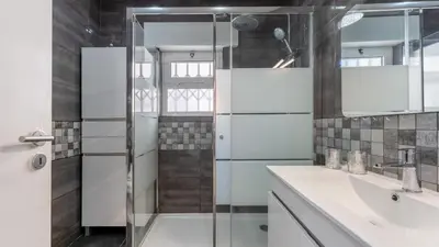 a bathroom with a shower and a sink at Cozy 2BR near Oura Beach by LovelyStay in Albufeira