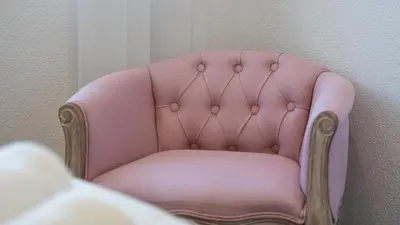 a pink chair sitting in a room at Cozy 2BR near Oura Beach by LovelyStay in Albufeira