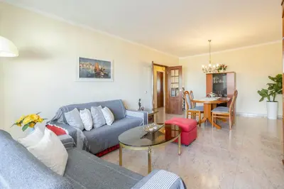 a living room with a couch and a table at TAC - Bright Coast Quarteira in Quarteira