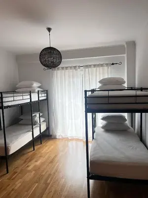 an empty room with a door and a tile floor at Ilumina Hostel Albufeira in Albufeira
