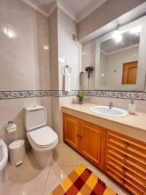 a bathroom with a toilet and a sink and a mirror at Ilumina Hostel Albufeira in Albufeira
