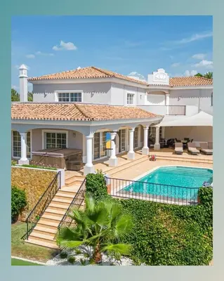 a large white house with a swimming pool at The Beverly Vilamoura in Quarteira