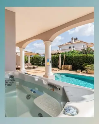 a swimming pool with a hot tub in a house at The Beverly Vilamoura in Quarteira
