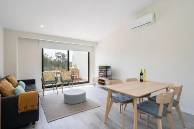 a living room with a table and a dining room at BmyGuest - Quinta do Lago Cosy Apartment in Quinta do Lago