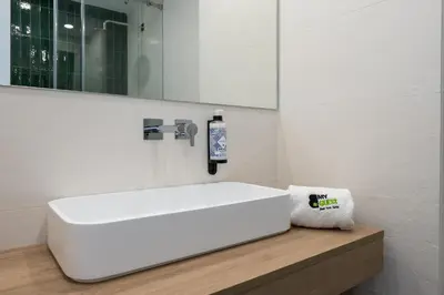 a bathroom with a white sink and a mirror at BmyGuest - Quinta do Lago Cosy Apartment in Quinta do Lago