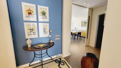 a living room with a white couch and a table at Casa da Praia By Garvetur in Albufeira