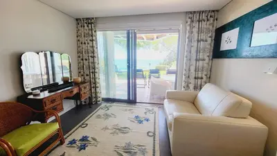 a living room with a white couch and a mirror at Casa da Praia By Garvetur in Albufeira