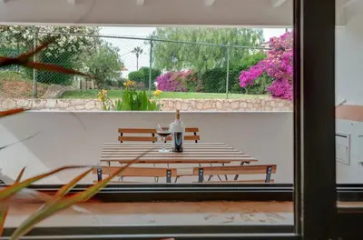 a man standing in front of a group of benches at Apartamento Condomínio Montechoro by CM Properties in Albufeira
