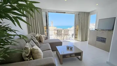 a living room with a couch and a tv and a table at Albufeira, Blue Wave Retreat 64 in Albufeira