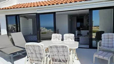 a white table and chairs on a balcony at Albufeira, Blue Wave Retreat 64 in Albufeira