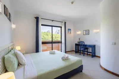 a bedroom with a bed and a desk and a window at Dream place- Bela Vista in Albufeira