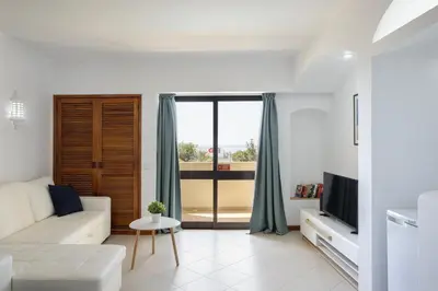 a living room with a white couch and a tv at Dream place- Bela Vista in Albufeira