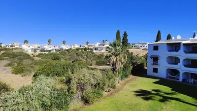 an aerial view of a building with trees and houses at Apartamento T2 86B na Praia Sao Rafael, Vista Mar - Albufeira in Albufeira