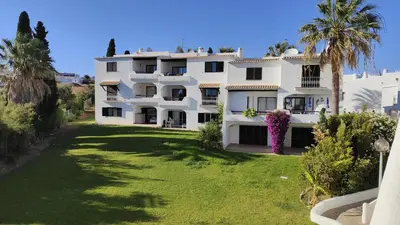 a large white building with a large yard at Apartamento T2 86B na Praia Sao Rafael, Vista Mar - Albufeira in Albufeira