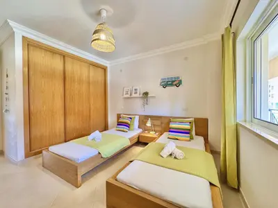 a bedroom with two beds and a window at Vilamoura Beach Village 1 With Pool by Homing in Vilamoura