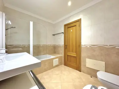 a bathroom with a sink and a tub and a toilet at Vilamoura Beach Village 1 With Pool by Homing in Vilamoura