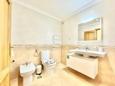 a bathroom with a toilet and a sink and a mirror at Vilamoura Beach Village 1 With Pool by Homing in Vilamoura