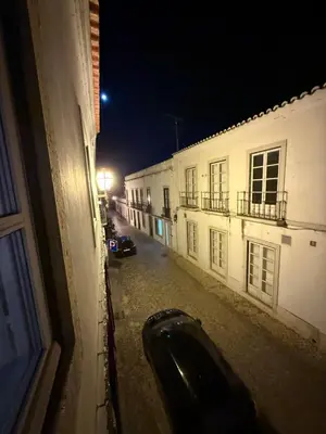 a car parked on a street at night at Faro Coast Guest House in Faro