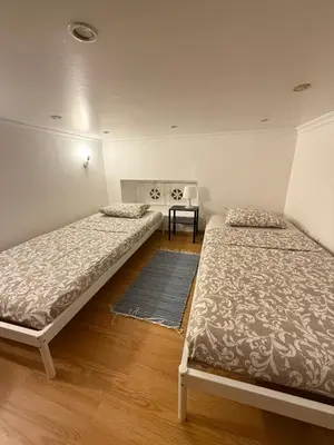 a room with two beds and a table in it at Faro Coast Guest House in Faro