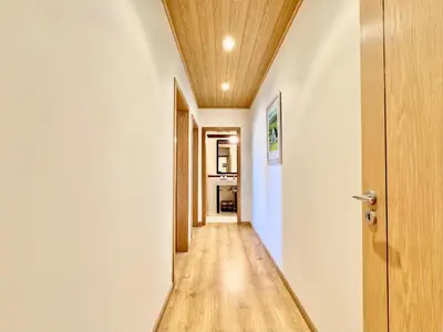 a hallway with white walls and a wooden ceiling at Vilamoura Lovely Beach Stay With Pool by Homing in Vilamoura