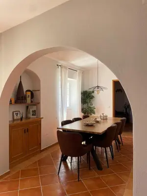 a dining room with a table and chairs at Quinta da Calma with pool and BBQ in Boliqueime