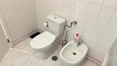 a small bathroom with a toilet and a bidet at Cozy Sea View in Albufeira