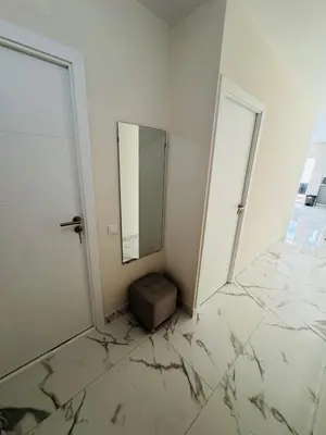 a white room with a mirror and a box on the floor at Excelente férias in Albufeira