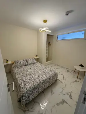 a bedroom with a bed on a marble floor at Excelente férias in Albufeira