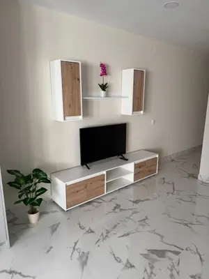 a living room with a television on a white wall at Excelente férias in Albufeira
