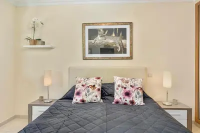 a bedroom with a bed with two pillows at Pool with Beach 10' Away - Comfort and Tranquility in Quarteira