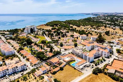 an aerial view of a city with buildings and the ocean at Falesia beach Pool quiet side by Enjoyyourstay in Albufeira