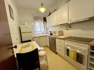 a small kitchen with a table and a refrigerator at OldTownPool Albufeira in Albufeira