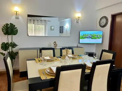 a dining room with a table and a tv at OldTownPool Albufeira in Albufeira