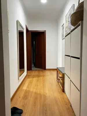 a hallway with white walls and a wooden floor at StayBaixa Faro in Faro