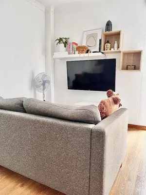 a gray couch in a living room with a television at StayBaixa Faro in Faro