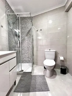 a bathroom with a toilet and a shower at StayBaixa Faro in Faro