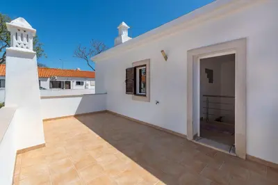 a white house with a patio and a doorway at Villa Ancora - Nex to the Beach - Parking - Swimming Pool - BY BEDZY in Albufeira
