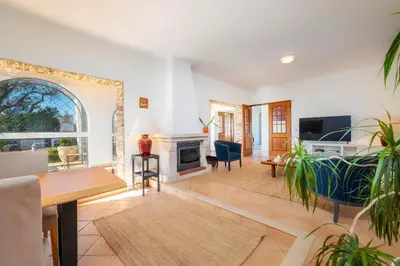 a living room filled with furniture and a fireplace at Villa 4 Quartos, Piscina, BBQ Snooker, Prestige For Home in Quarteira