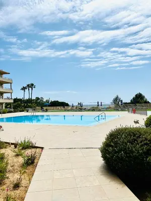 a swimming pool with the ocean in the background at Albufeira Comfort Luxury Quinta Barracuda in Albufeira