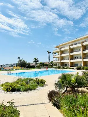 a swimming pool in front of a hotel at Albufeira Comfort Luxury Quinta Barracuda in Albufeira