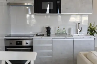 a kitchen with a sink and a stove at Vilamoura Retreat - Sunset View by HD in Vilamoura