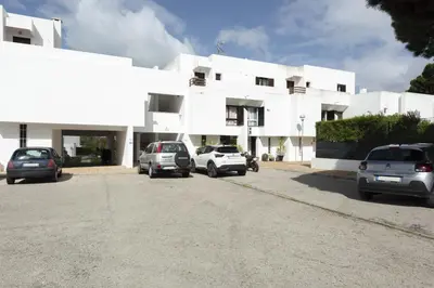 a white building with cars parked in front of it at Vilamoura Retreat - Sunset View by HD in Vilamoura