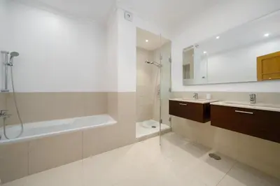 a bathroom with a tub and a sink and a shower at Palmyra Apartments in Vilamoura in Vilamoura
